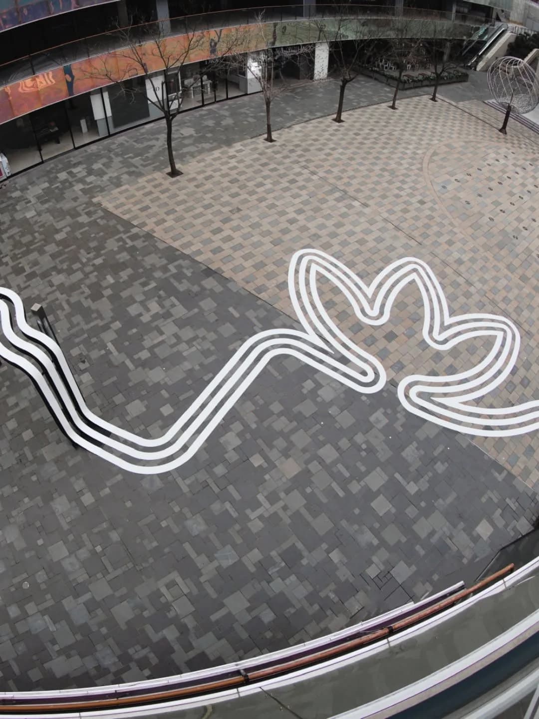 Winding white Three Stripes path across the Beijing Sanlitun plaza