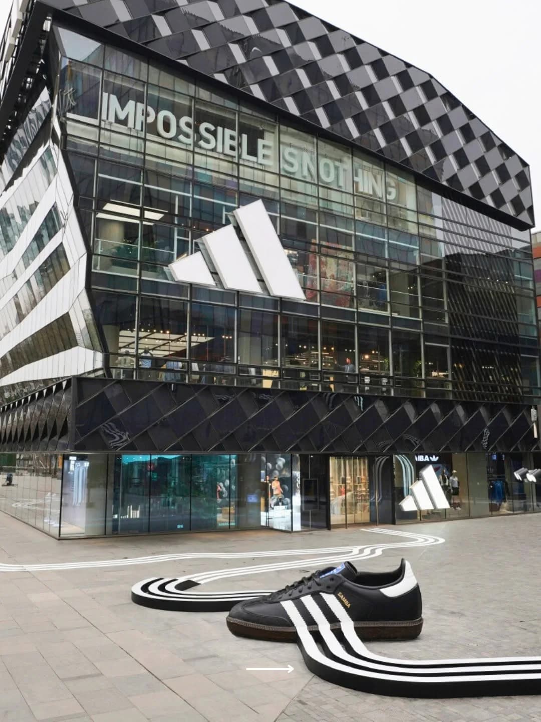 Adidas Beijing storefront with a giant Samba and Three Stripes installation