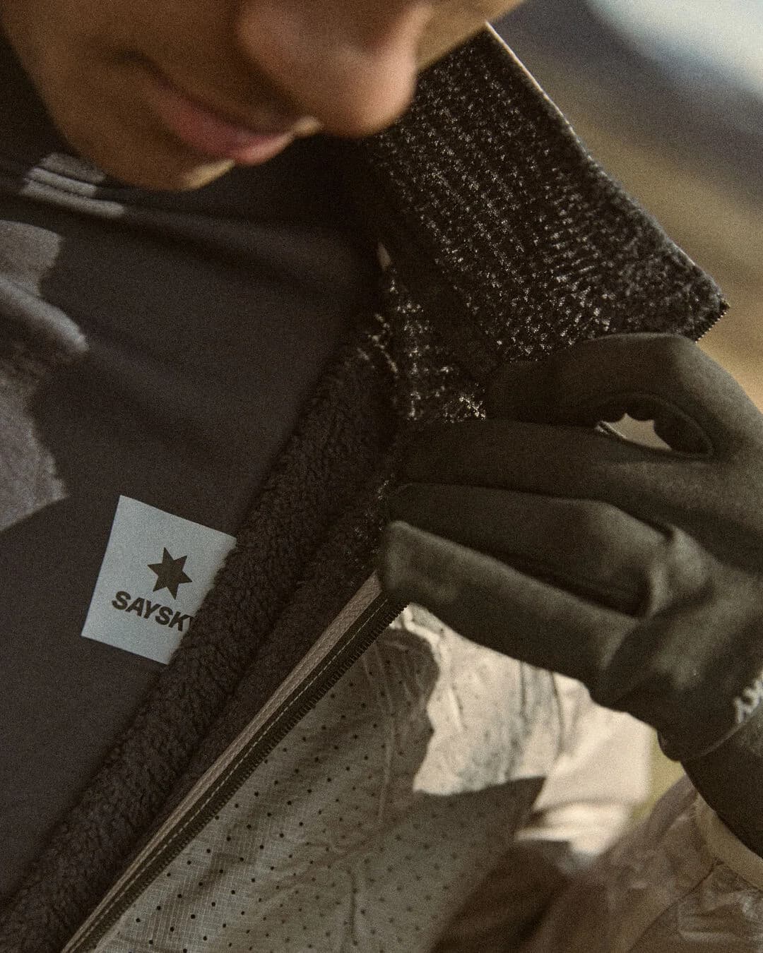 Close-up of a runner in a SAYSKY fleece and gloves