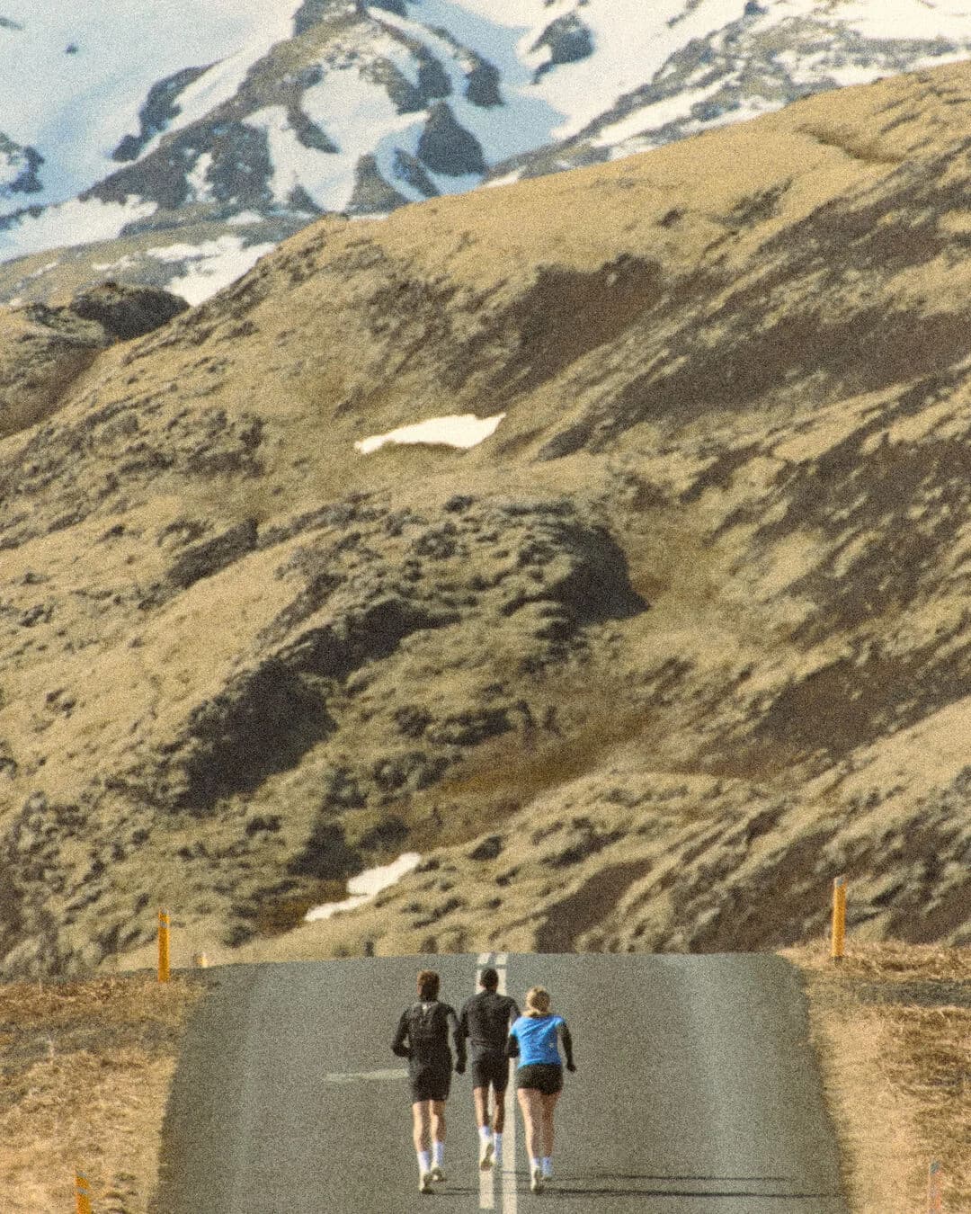 Three runners in SAYSKY apparel heading toward Icelandic mountains