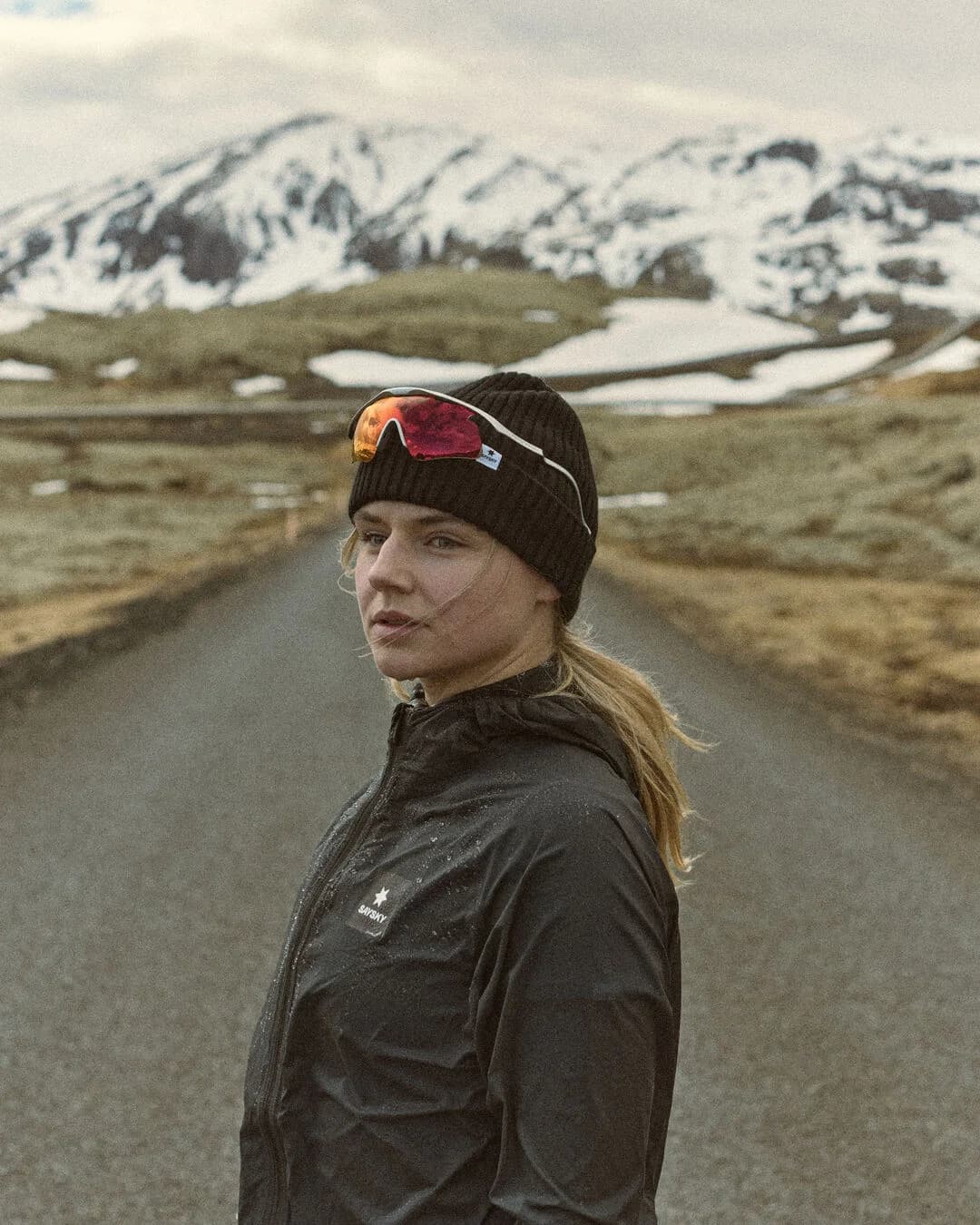 Runner in black SAYSKY outerwear on an Icelandic road