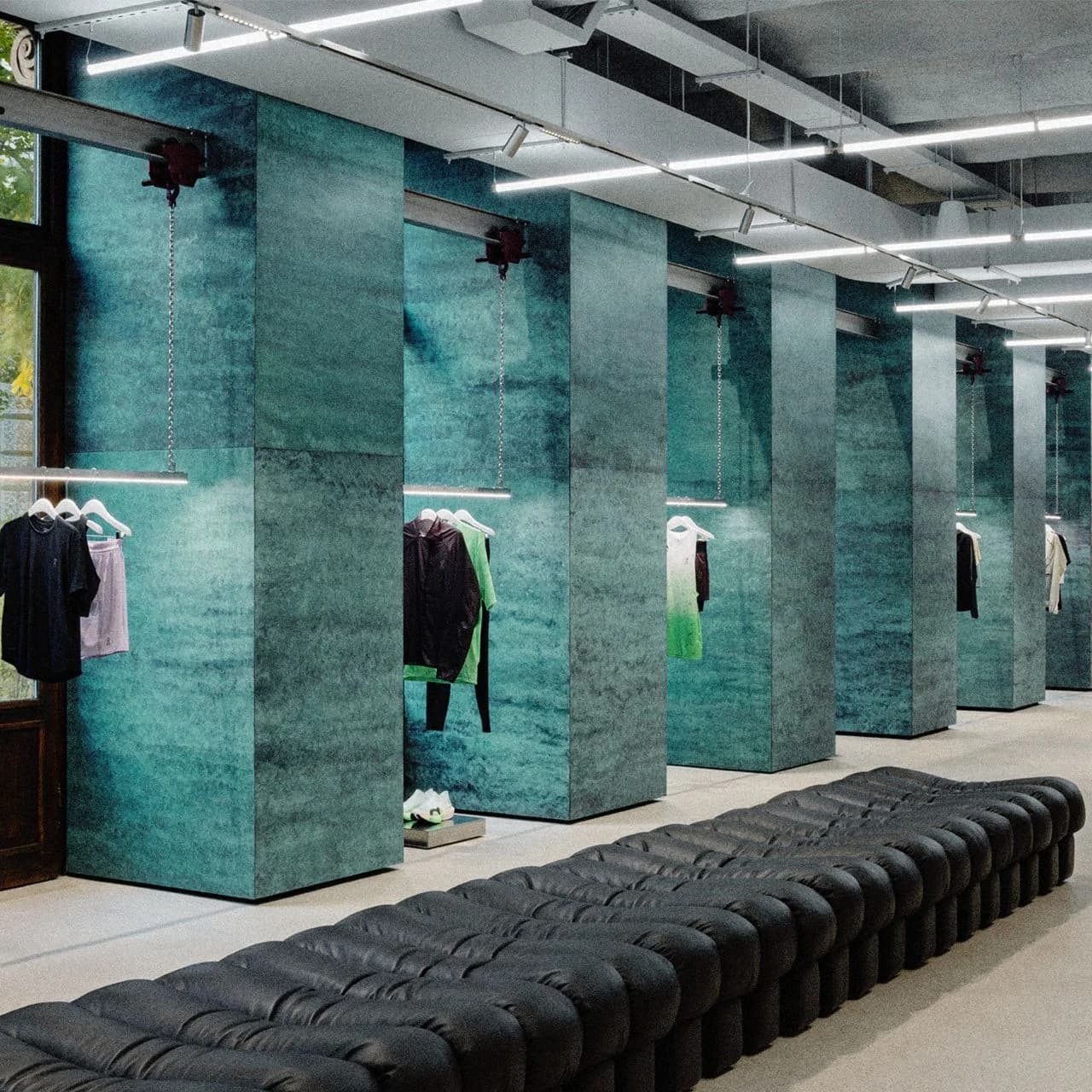 On Vienna store interior with teal panels and apparel displays