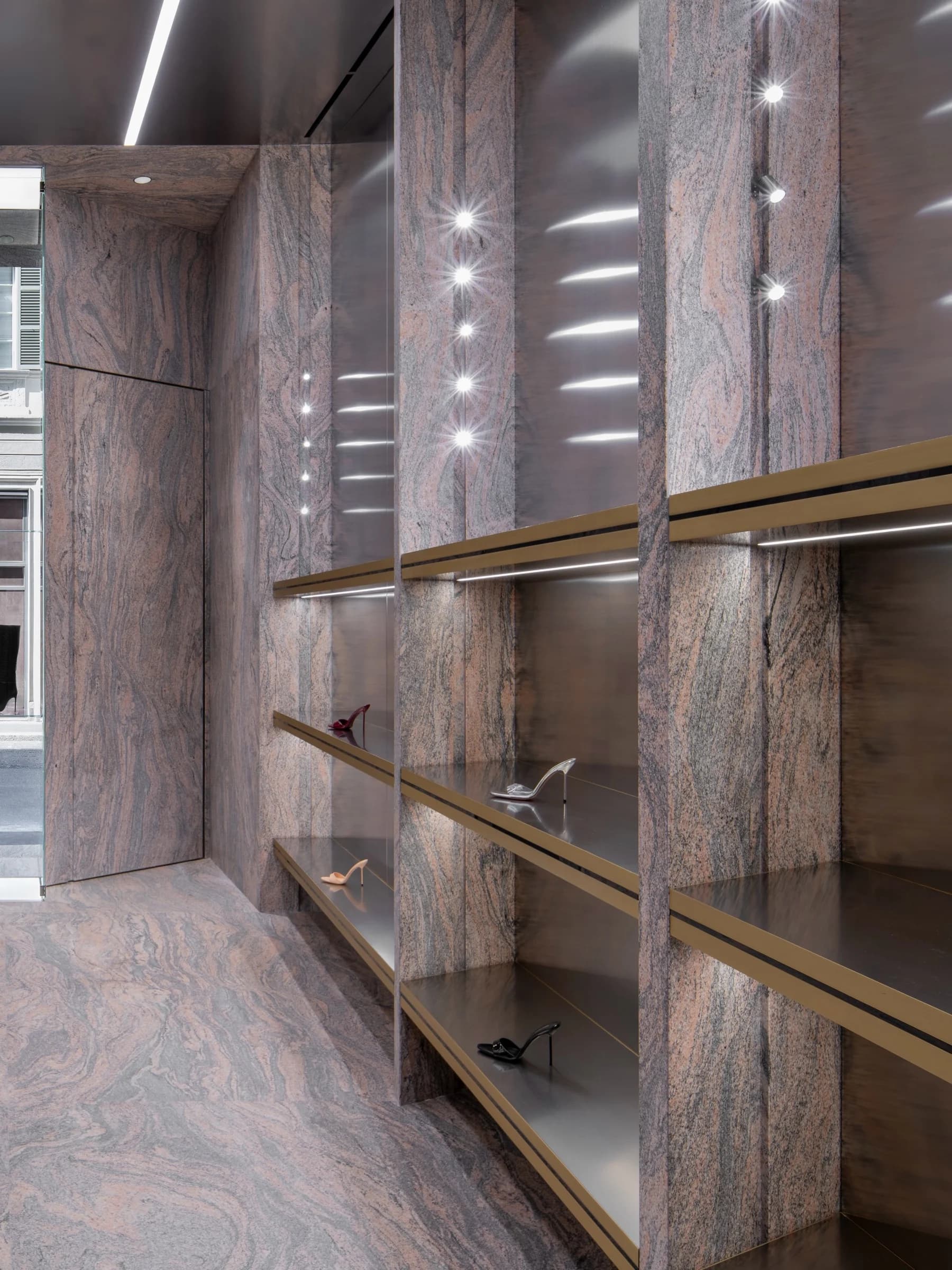 Minimal shelving and stone finishes inside the Paris Texas Milan store