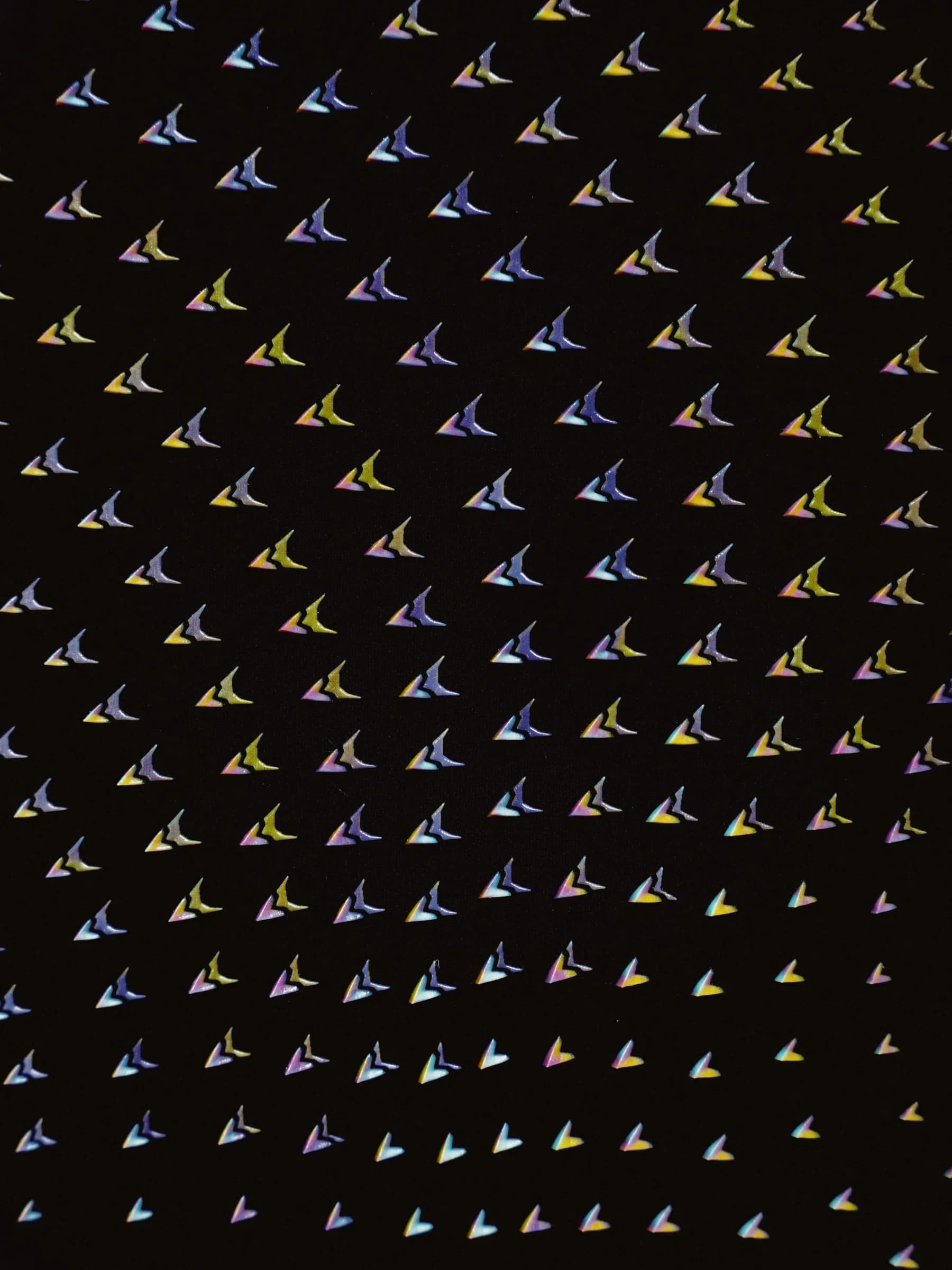 Close view of colorful aerodynamic devices on black Nike speed suit fabric