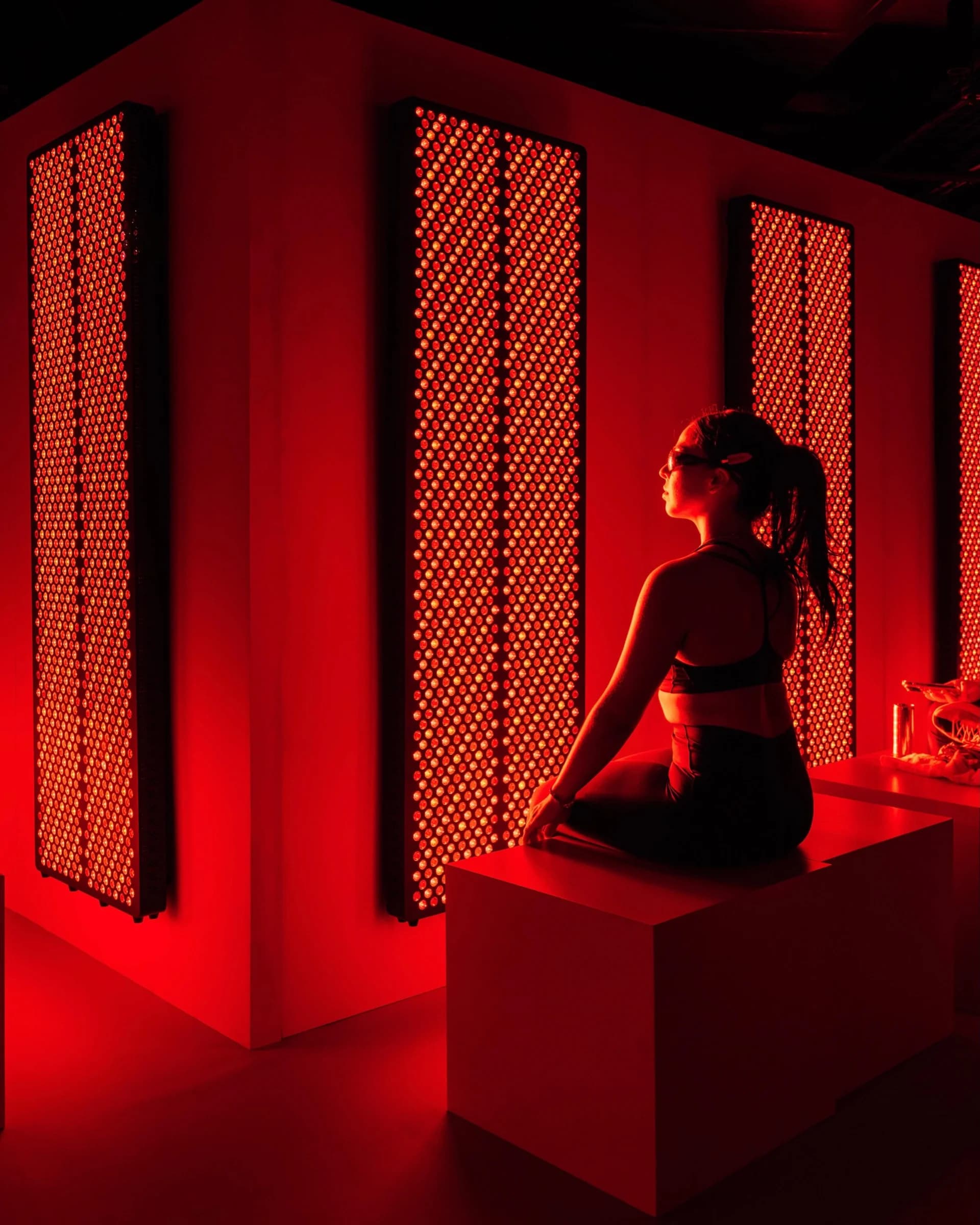 H&M Move event attendee seated in a red light recovery room