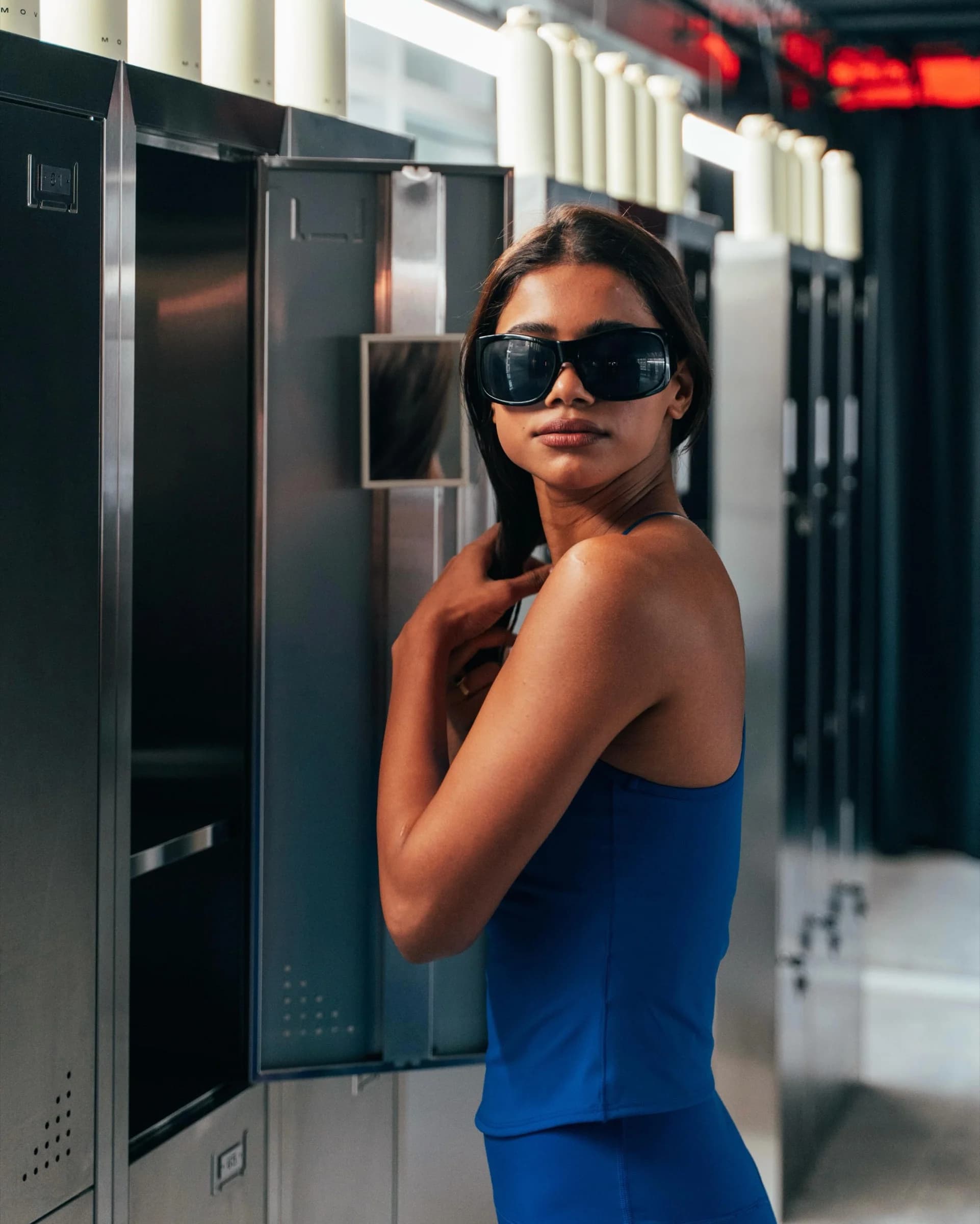 H&M Move event attendee in a blue training set beside gym lockers