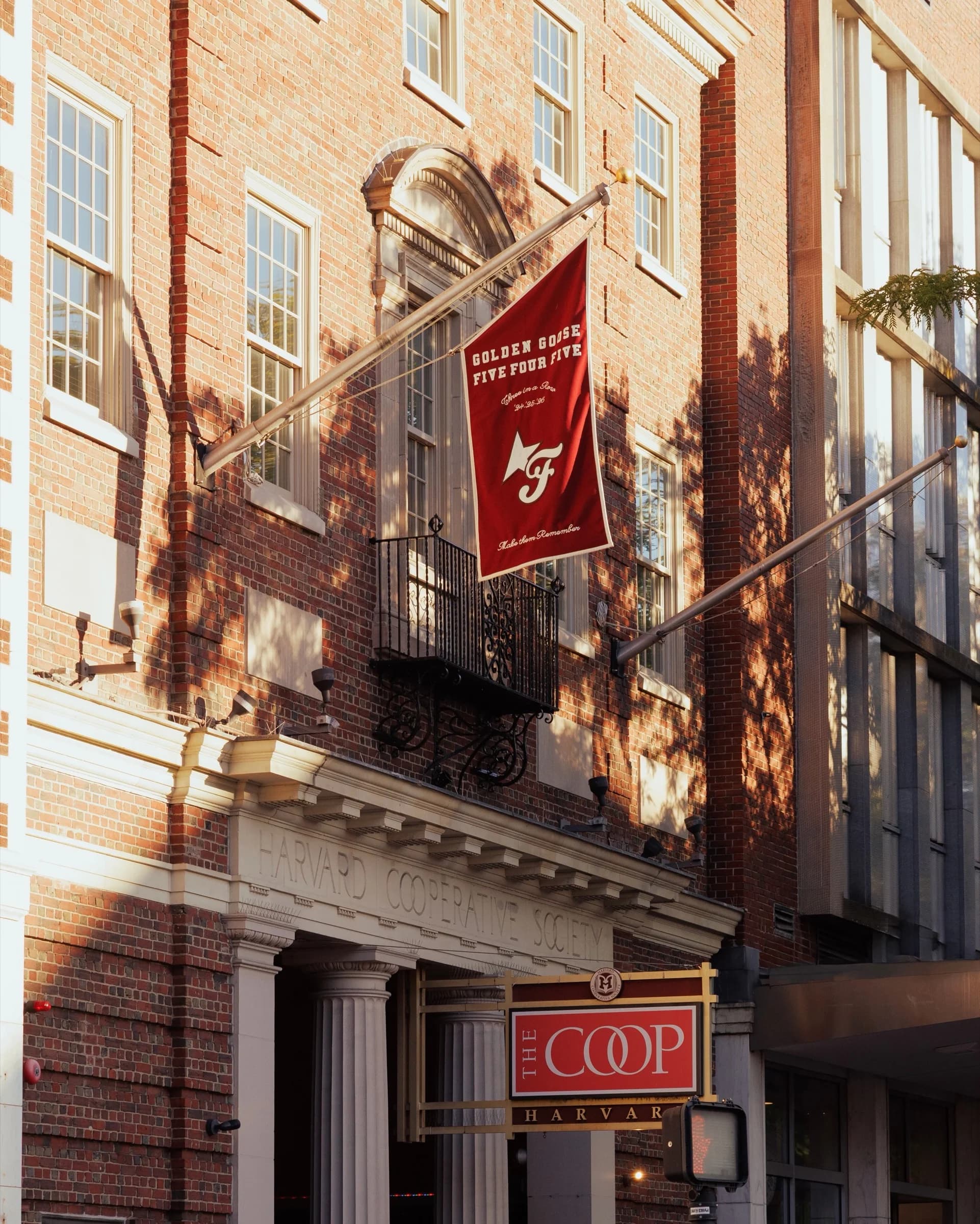 Golden Goose and FiveFourFive flag outside The COOP in Harvard Square