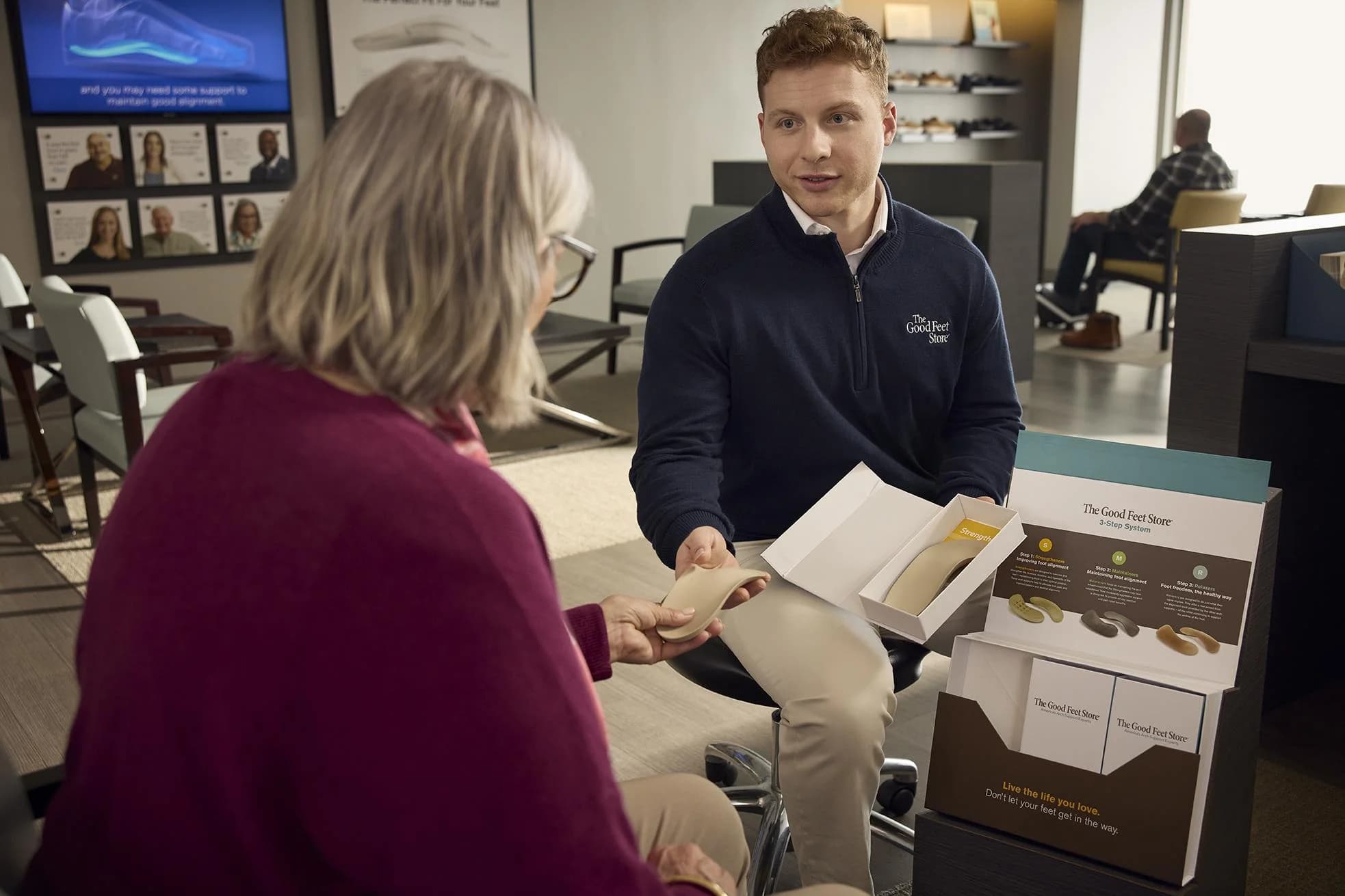Arch support specialist helping a customer during a store fitting