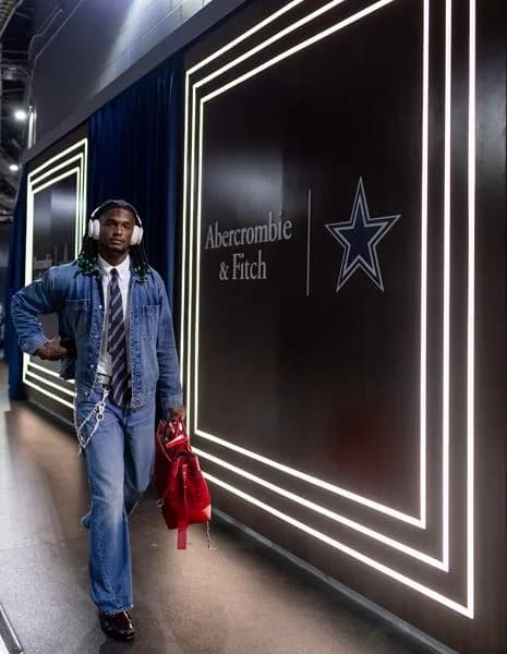 Cowboys player walks past Abercrombie and Dallas Cowboys tunnel branding
