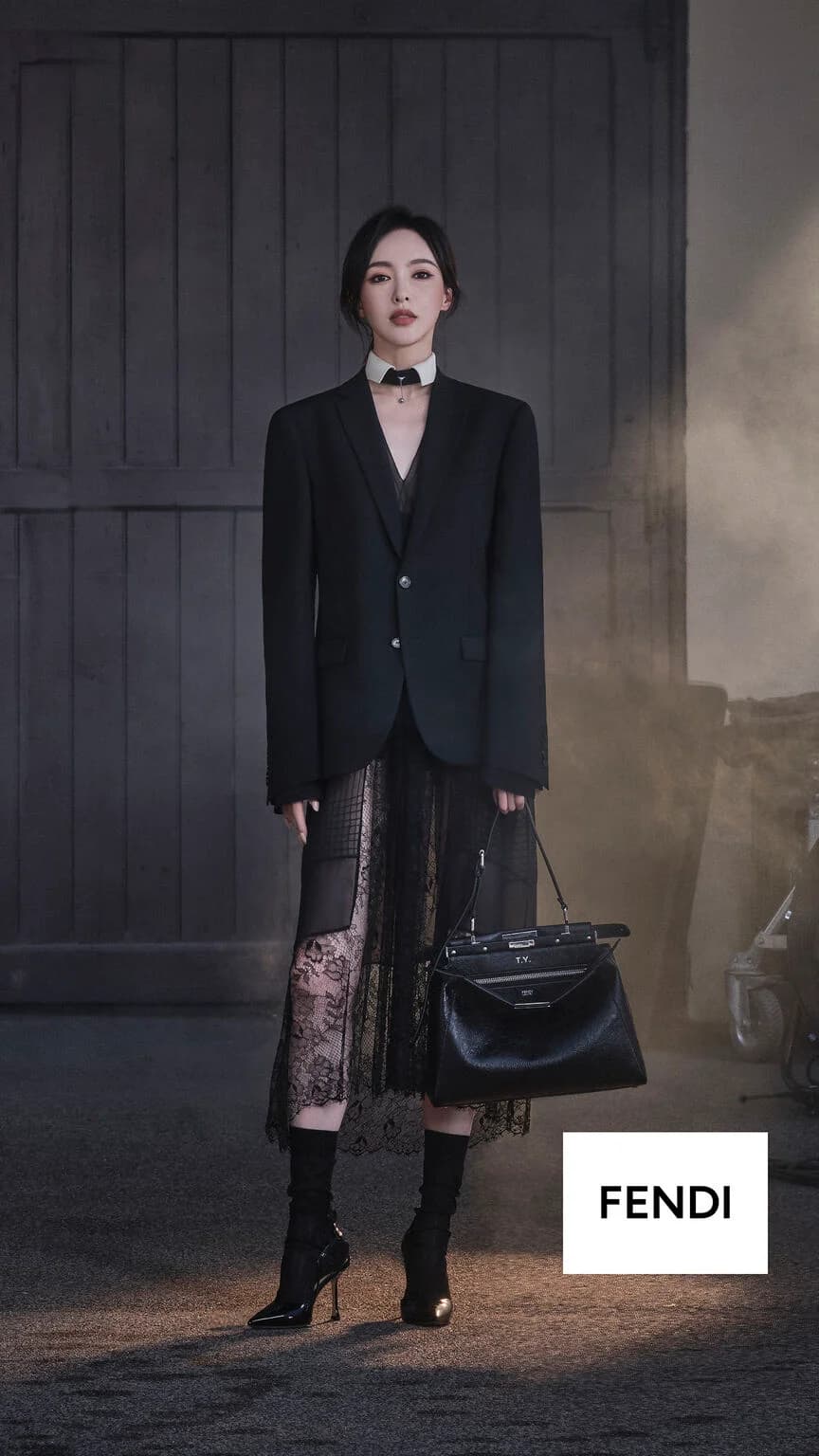 Fendi My Peekaboo campaign with a woman wearing a black blazer and lace skirt holding a personalized black bag