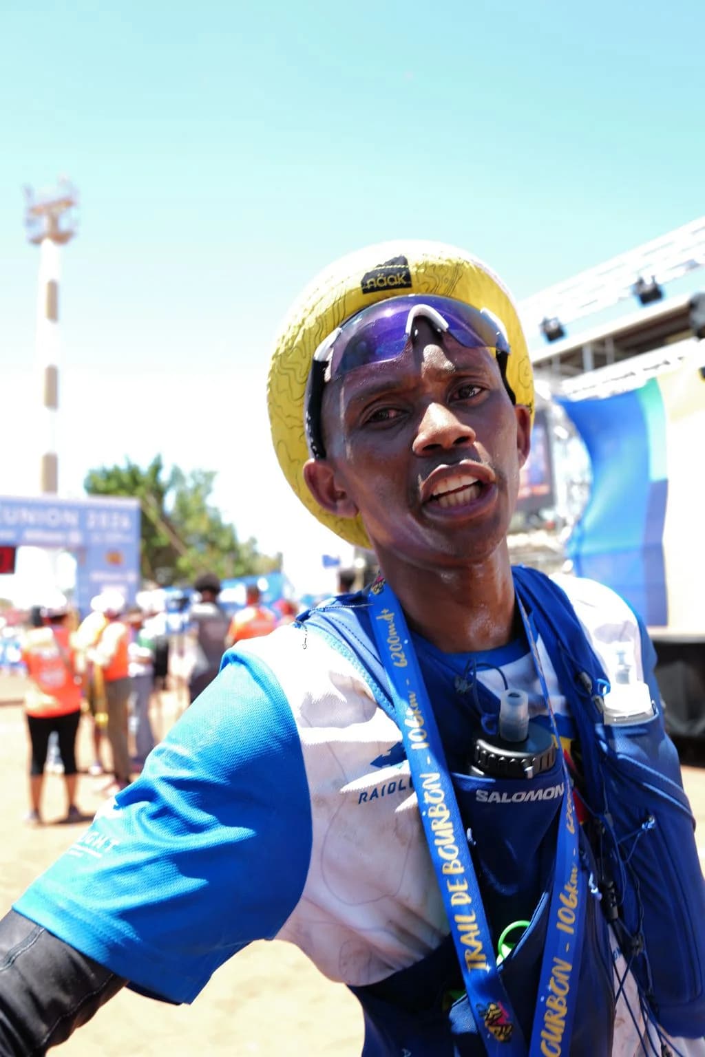 Trail runner in a Salomon hydration vest at a race finish