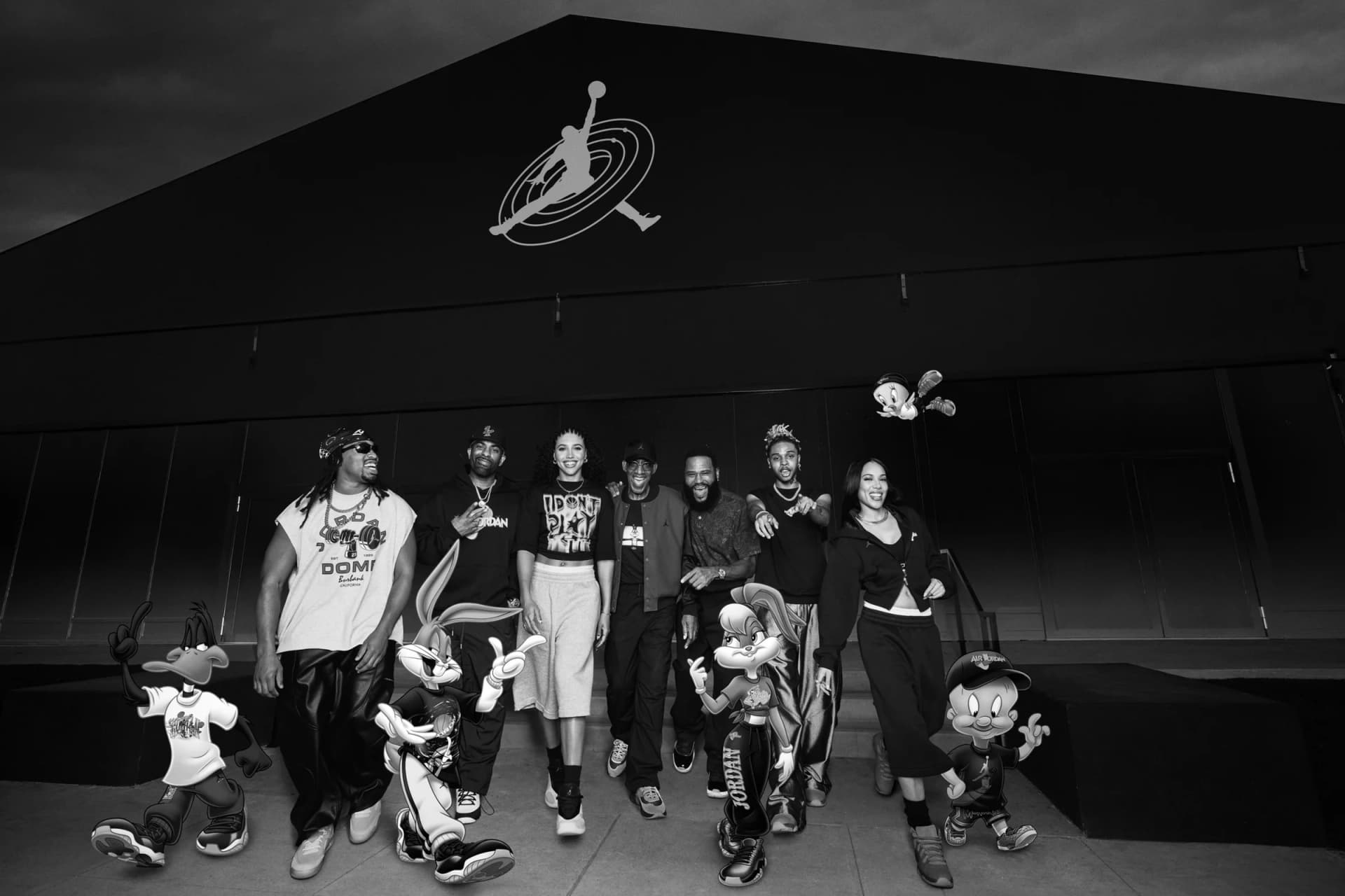 Jordan Brand campaign group stands outside a building with Space Jam characters.