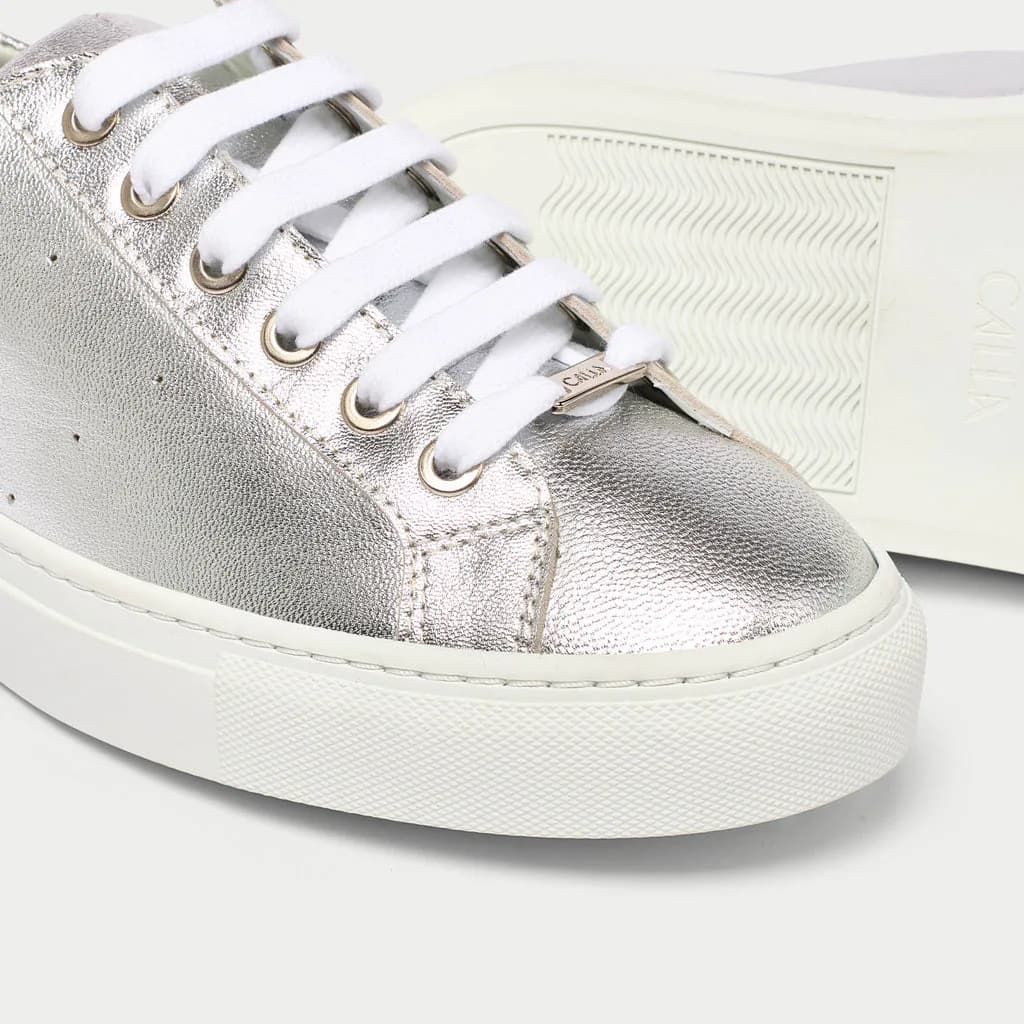 Close-up of the Calla Star silver metallic sneaker with white laces and sole