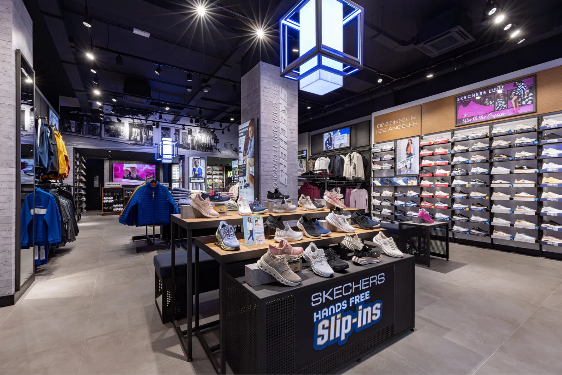 Interior of the Skechers Milan flagship with Slip-ins display tables and blue cube lights