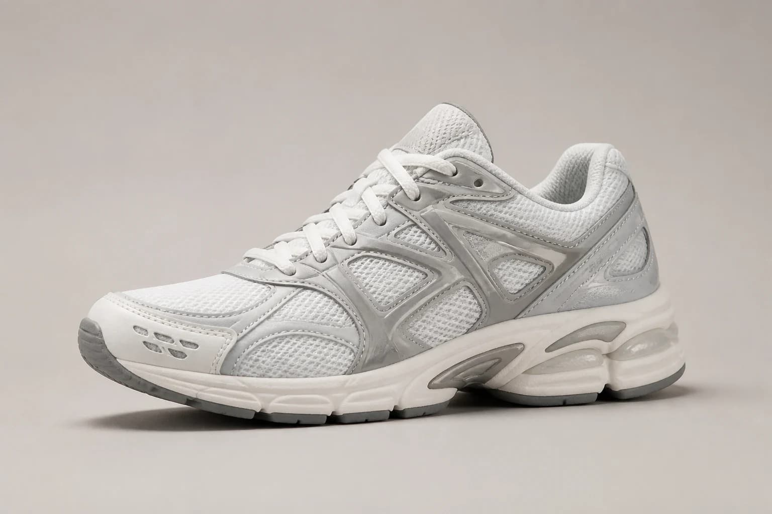 Unbranded white and cloud gray mesh stability-style sneaker on a pale gray set