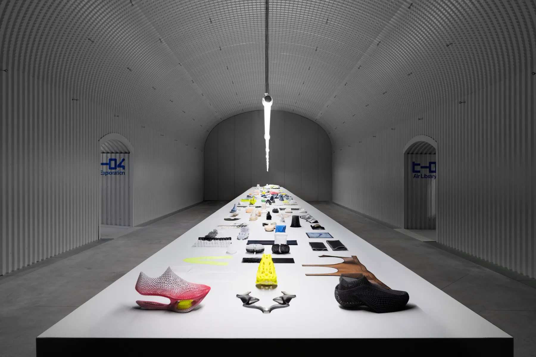 Long gallery table displaying colorful Nike Air prototypes and components