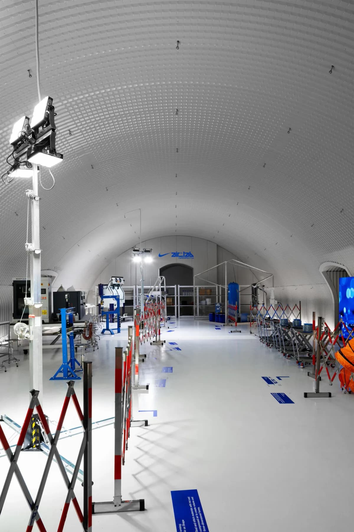 White vaulted Nike Air Lab workspace lined with testing equipment