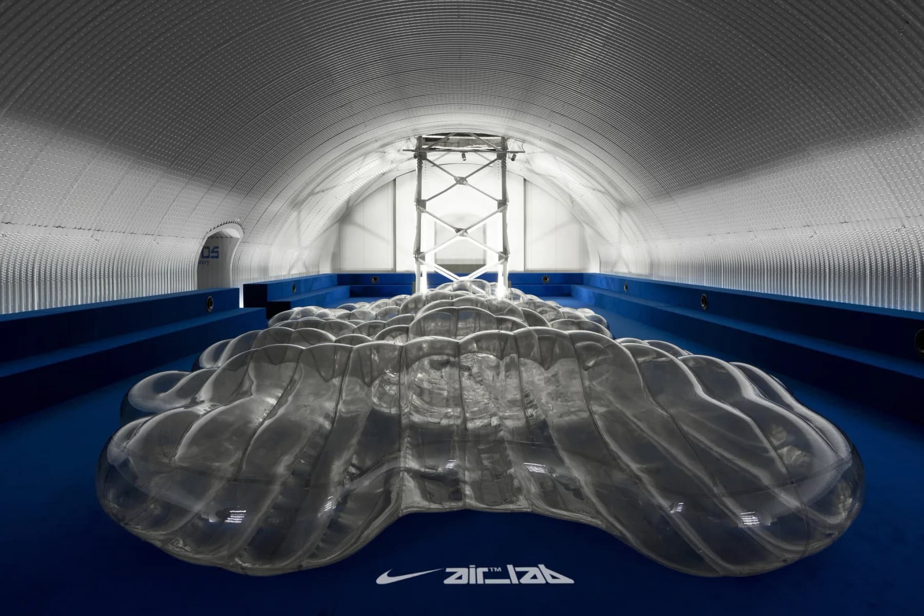 Large transparent Nike Air cushion displayed inside a blue-lined chamber