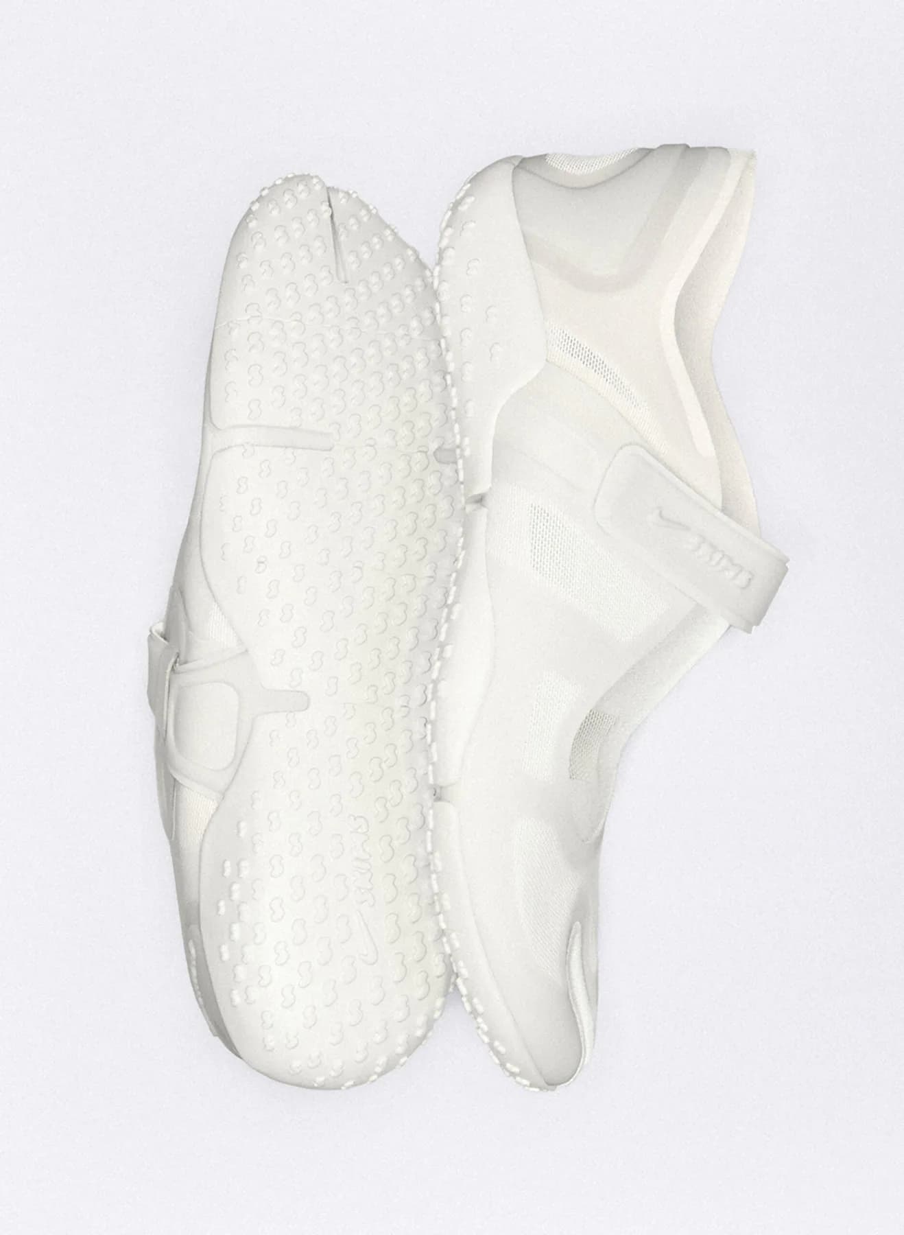 White NikeSKIMS Rift Mesh split-toe shoes shown from the side and sole