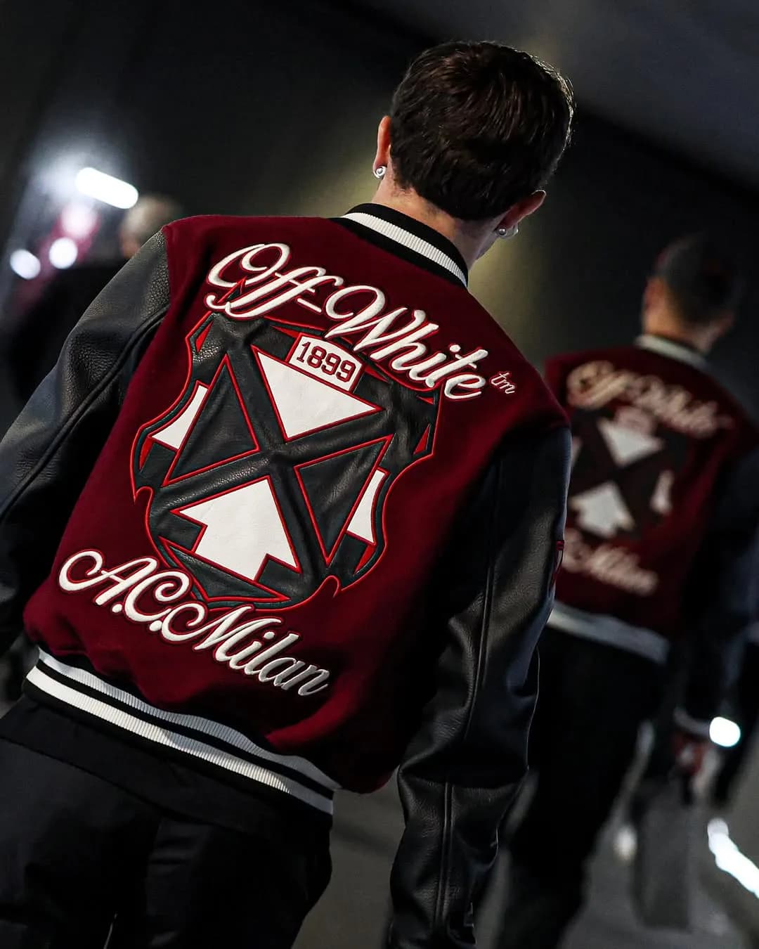 Rear view of the Off-White x AC Milan varsity jacket with arrow graphics