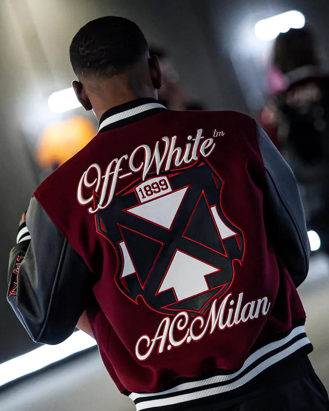 Close rear view of the Off-White x AC Milan varsity jacket arrow graphic
