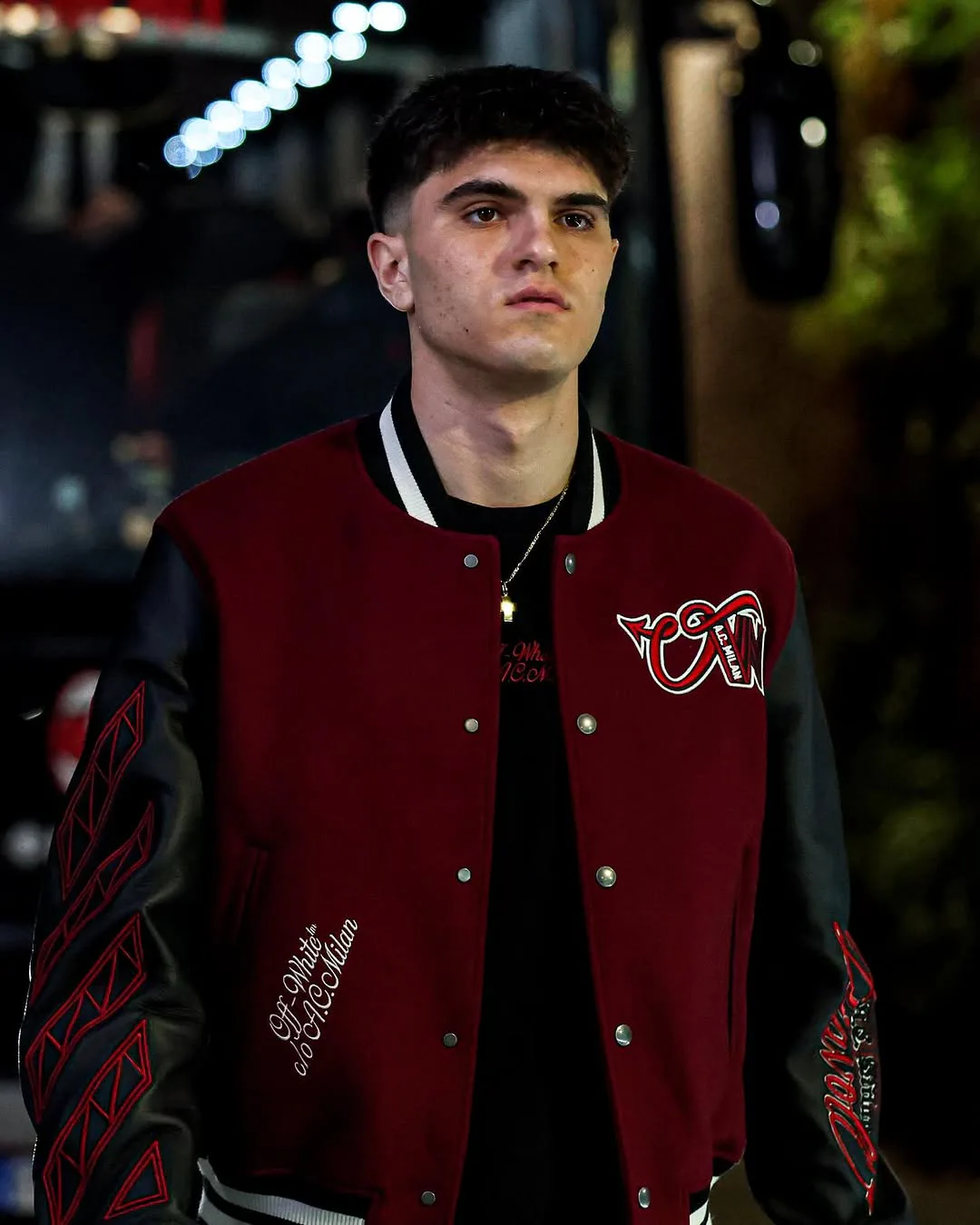 AC Milan player wearing the front of a red-and-black Off-White varsity jacket