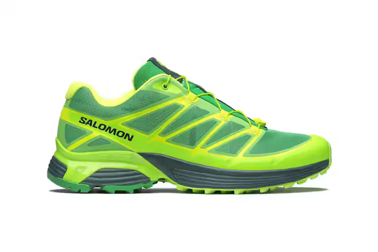 Green and yellow Salomon trail running shoe in side profile