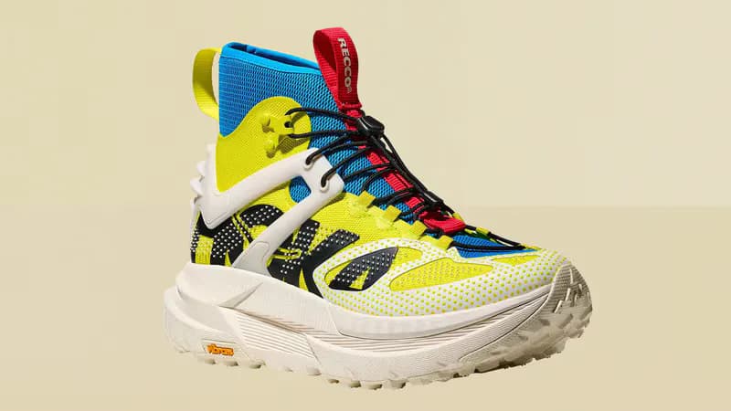 Yellow, blue, and red high-top trail shoe with a white Vibram outsole
