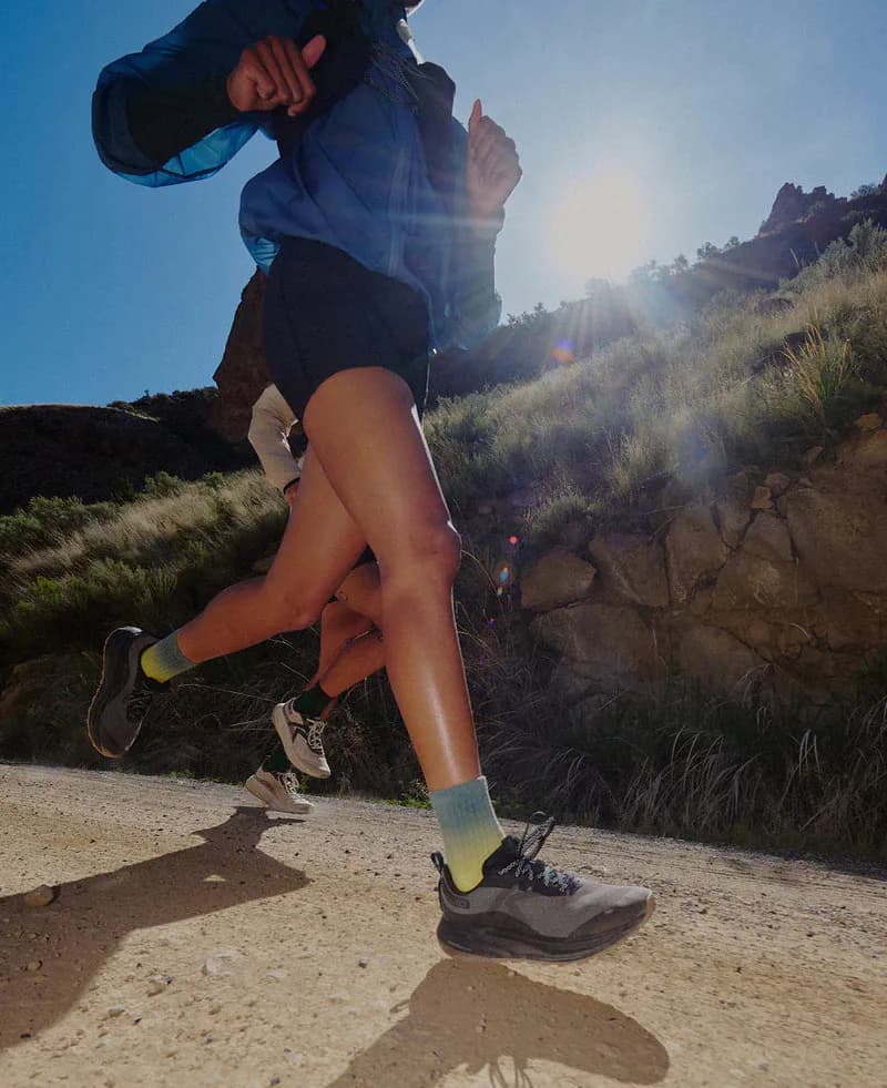 Trail runners on a sunlit rocky mountain path
