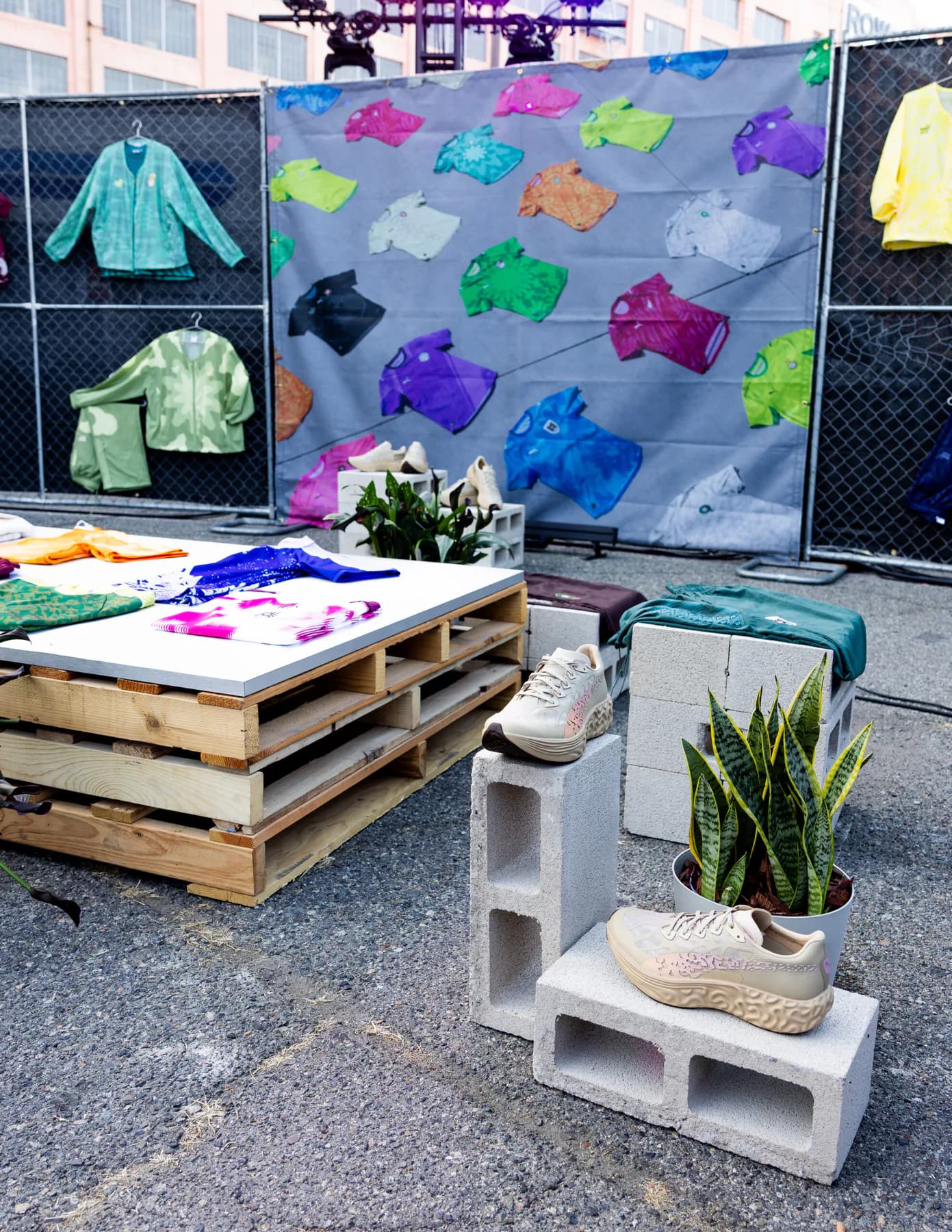PUMA x Salehe Bembury apparel and Velum sneakers displayed on pallets and concrete blocks