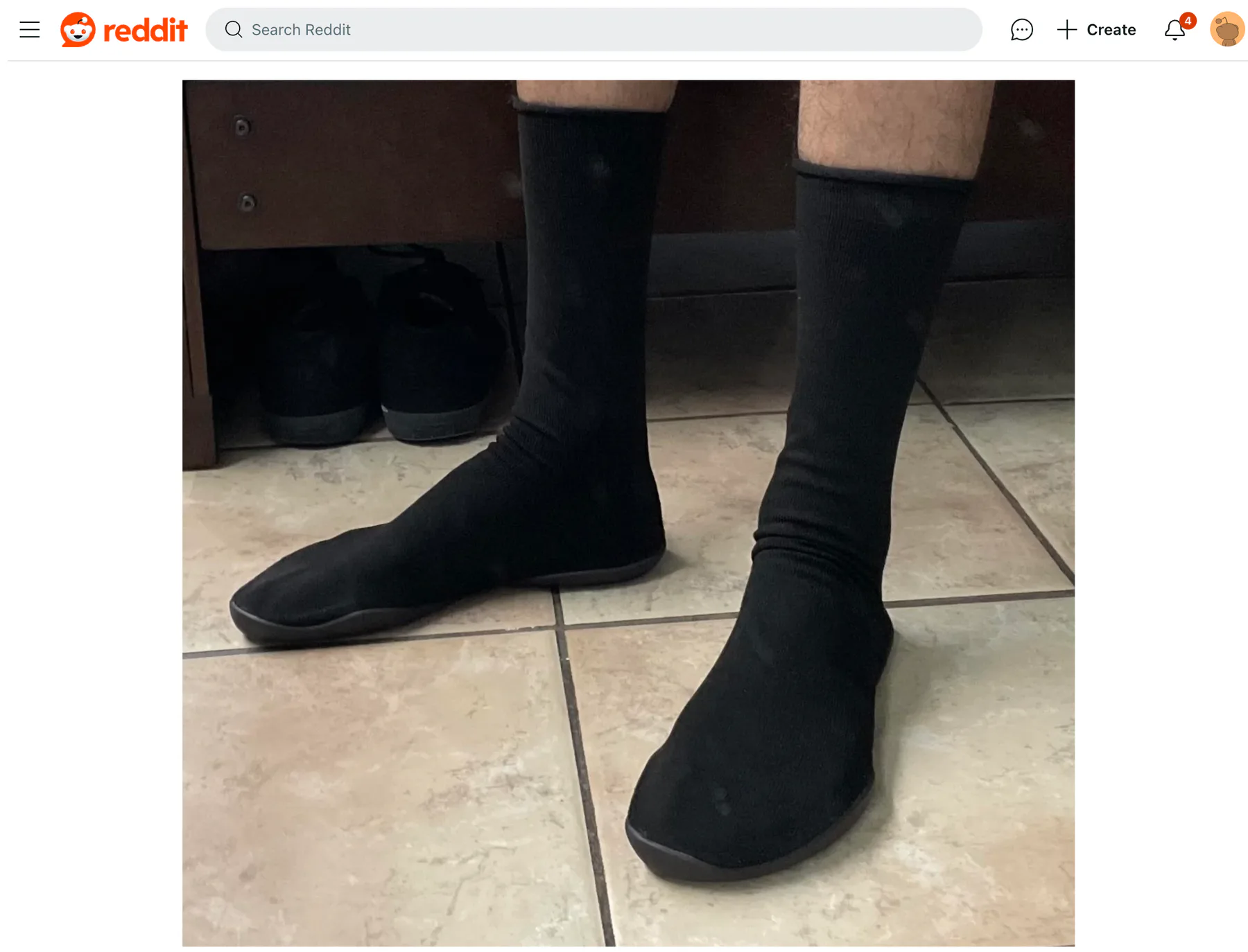 Person wearing black Yeezy Pods in a Reddit review screenshot
