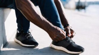 Man tying his left shoelaces