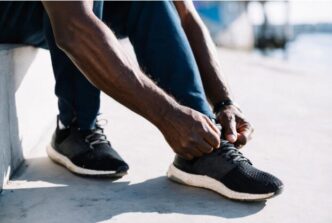 Man tying his left shoelaces